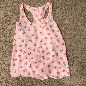 Pink tank top with cherry pattern.